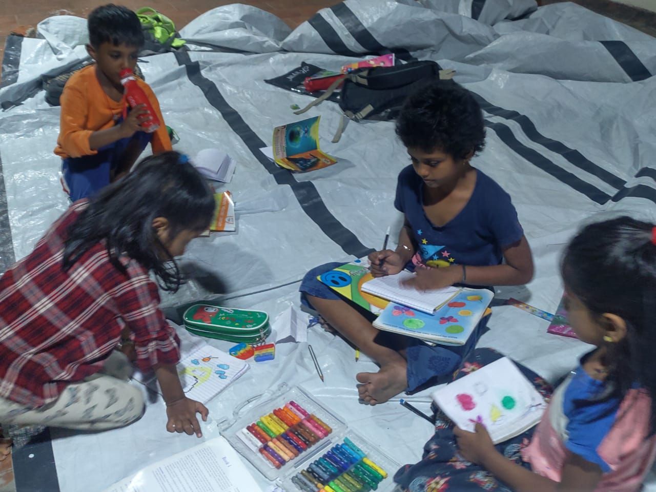 Children drawing and colouring with crayons
